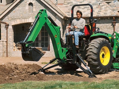 compact tractor digging hole