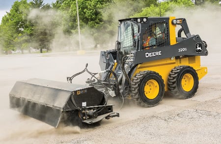 John Deere 320G equipped with an angle broom