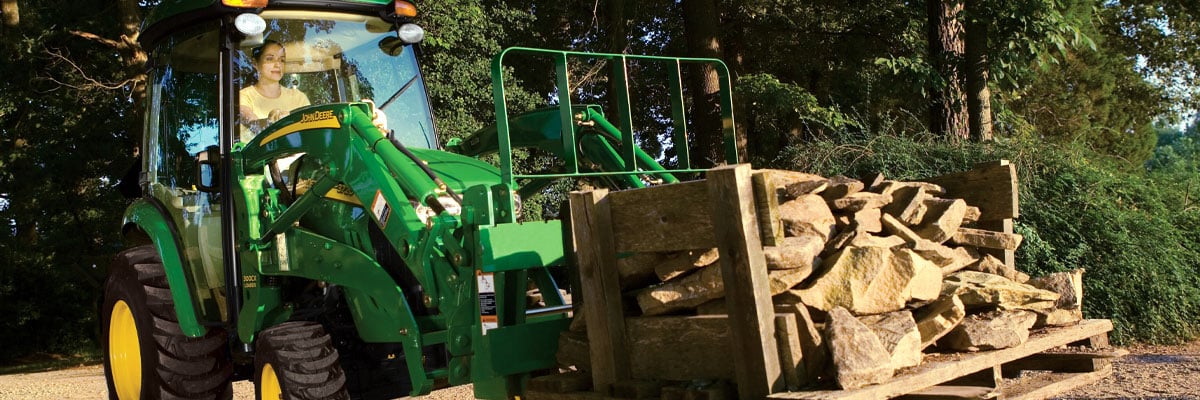 small tractor carrying rocks