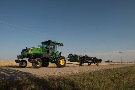 1400D integrated slow-speed transport system behind W170 Windrower