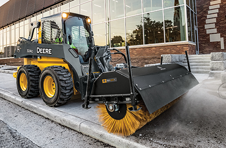 John Deere 324G equipped with an angle broom