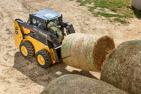 John Deere 316GR equipped with bale spear