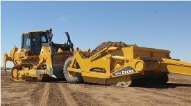 John Deere crawler pushes an ejector scraper