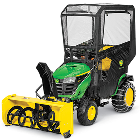 Snow blower, weather enclosure, weights, and chains on a 100 Series Tractor