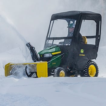 X590 Tractor shown with optional snow blower and weather enclosure