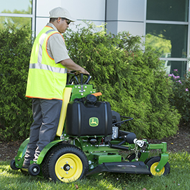 Operator trimming with 636M QuikTrak© Mower