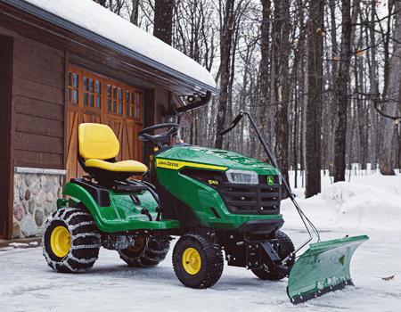 S140 Tractor with front blade, weights, and tire chains