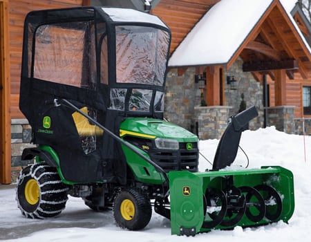 S160 Tractor with snow blower, weather enclosure, weights, and tire chains