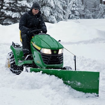 48-in. (122-cm) Front Blade, angling and tire chains on an X590 Tractor