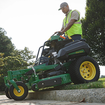 Q820M QuikTrak Mower traversing a curb