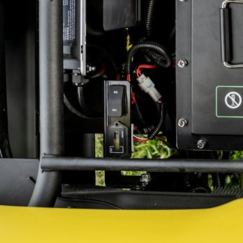 Tow switch and hour meter (shown with seat cushion and storage tray removed)